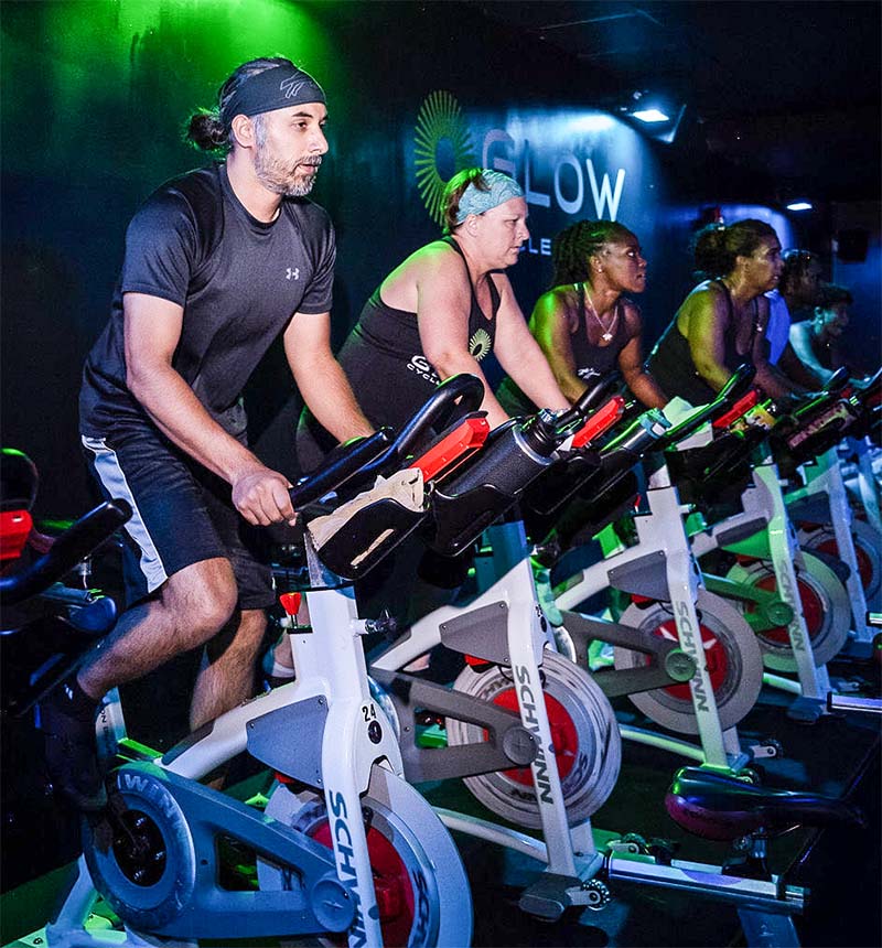 Glow Cycle fitness class with men in Columbia, MD.